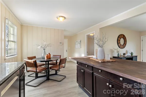 a kitchen with stainless steel appliances granite countertop a sink cabinets and wooden floor