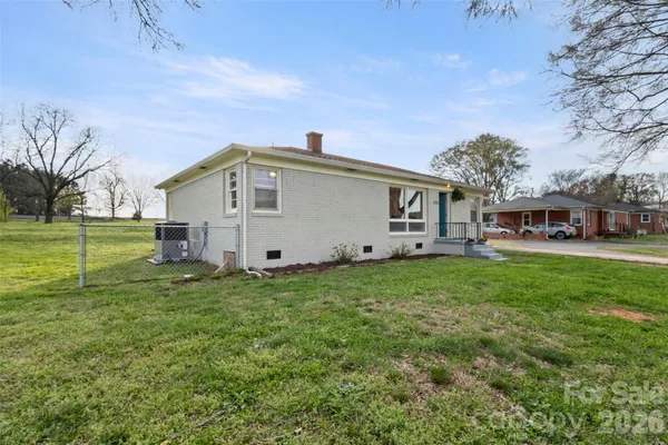 a living room with furniture a mirror and a chandelier