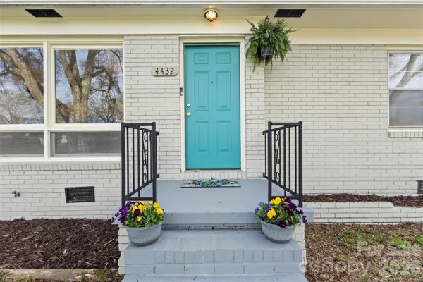 a living room with stainless steel appliances kitchen island granite countertop furniture and a view of kitchen