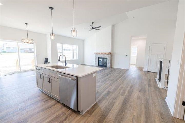 14200 Prairie Commons Lane South Beloit, IL 61080 - Photo 4 of 13 a kitchen with stainless steel appliances granite countertop a sink stove and wooden floor