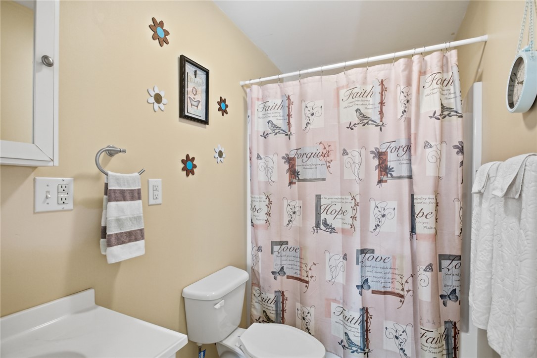 108 Hodge Street Abbeville, SC 29620 - Photo 23 of 39 A well-appointed bath with practical fixtures and a decorative shower curtain.