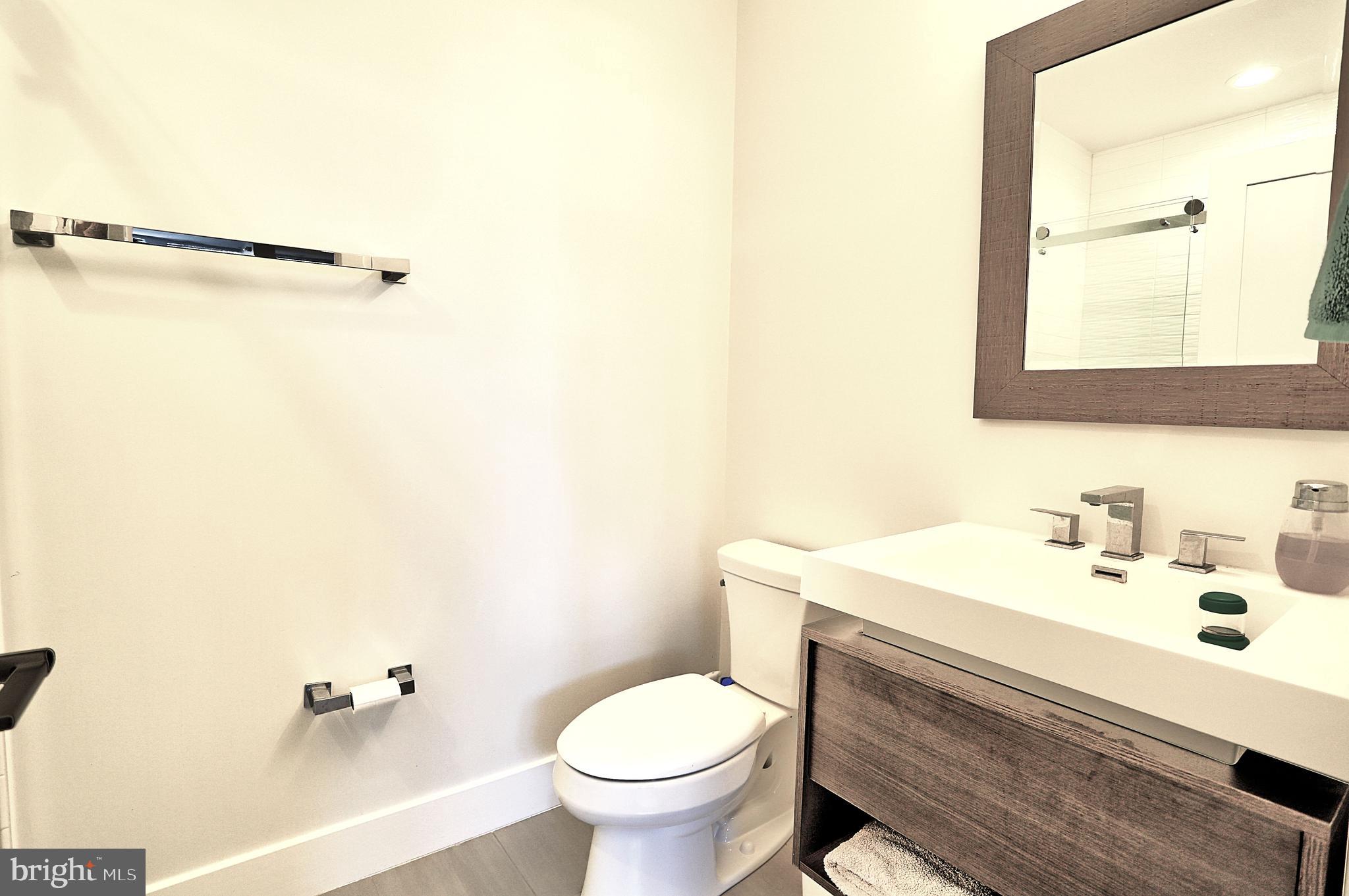 1723 Wisconsin Avenue Northwest, Unit C Washington, DC 20007 - Photo 11 of 18 a bathroom with a sink toilet and a mirror