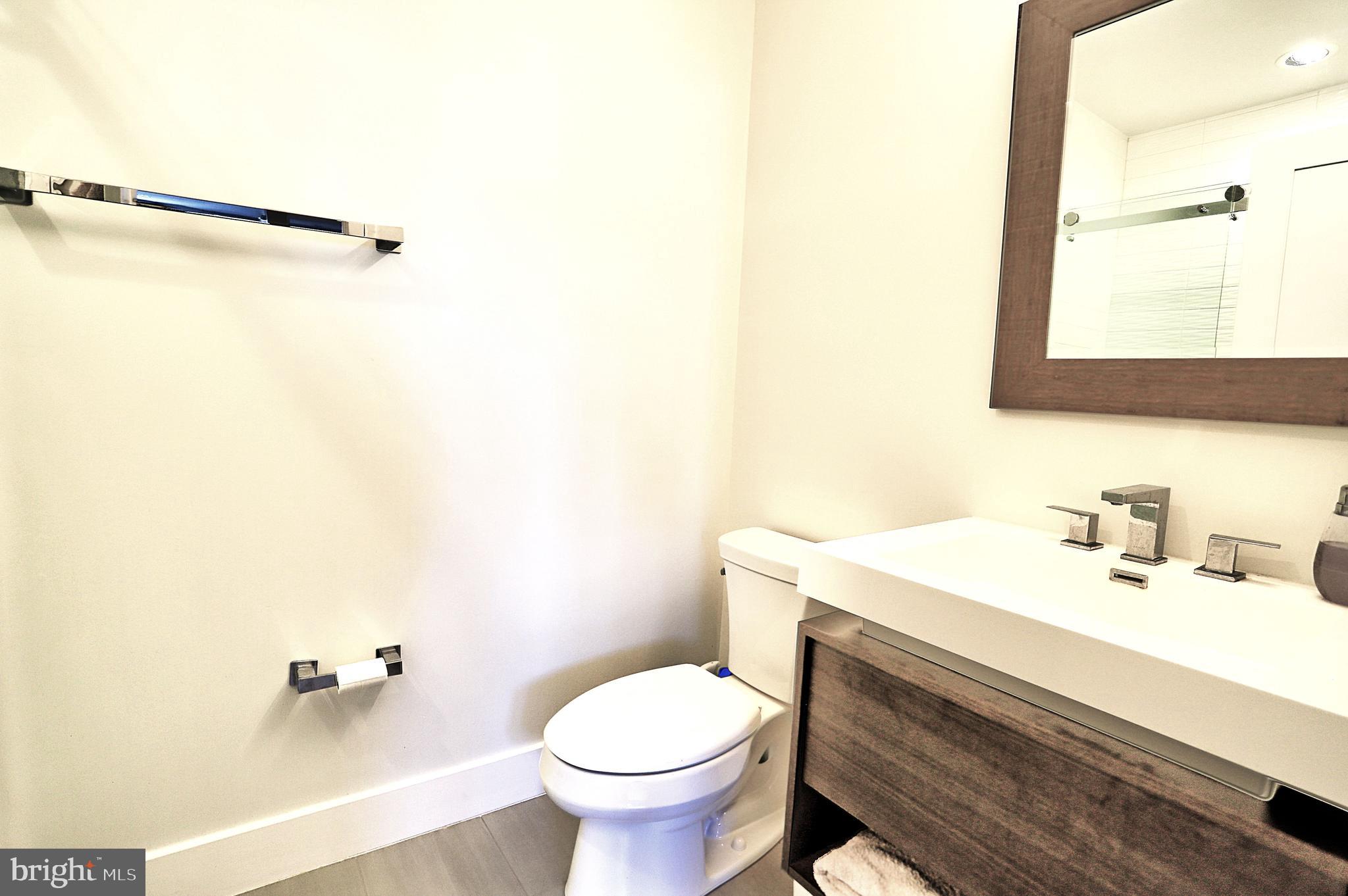 1723 Wisconsin Avenue Northwest, Unit C Washington, DC 20007 - Photo 12 of 18 a bathroom with a sink toilet and mirror