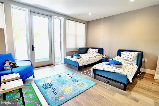 a bedroom with two beds and a couch