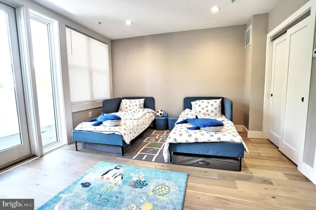 a bedroom with two beds and a window