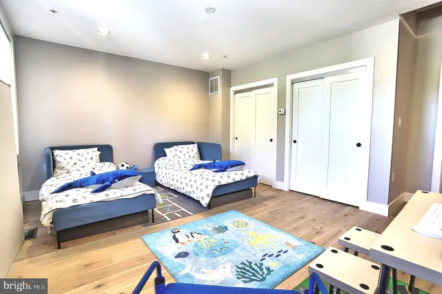 a bedroom with furniture and a wooden floor