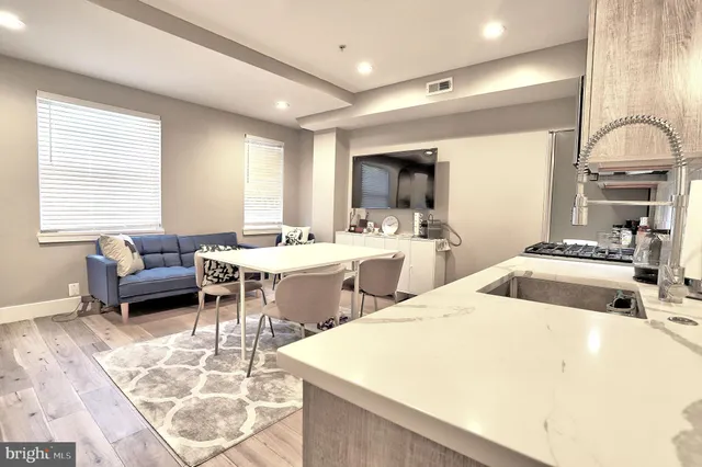 a room with furniture a flat screen tv and a window