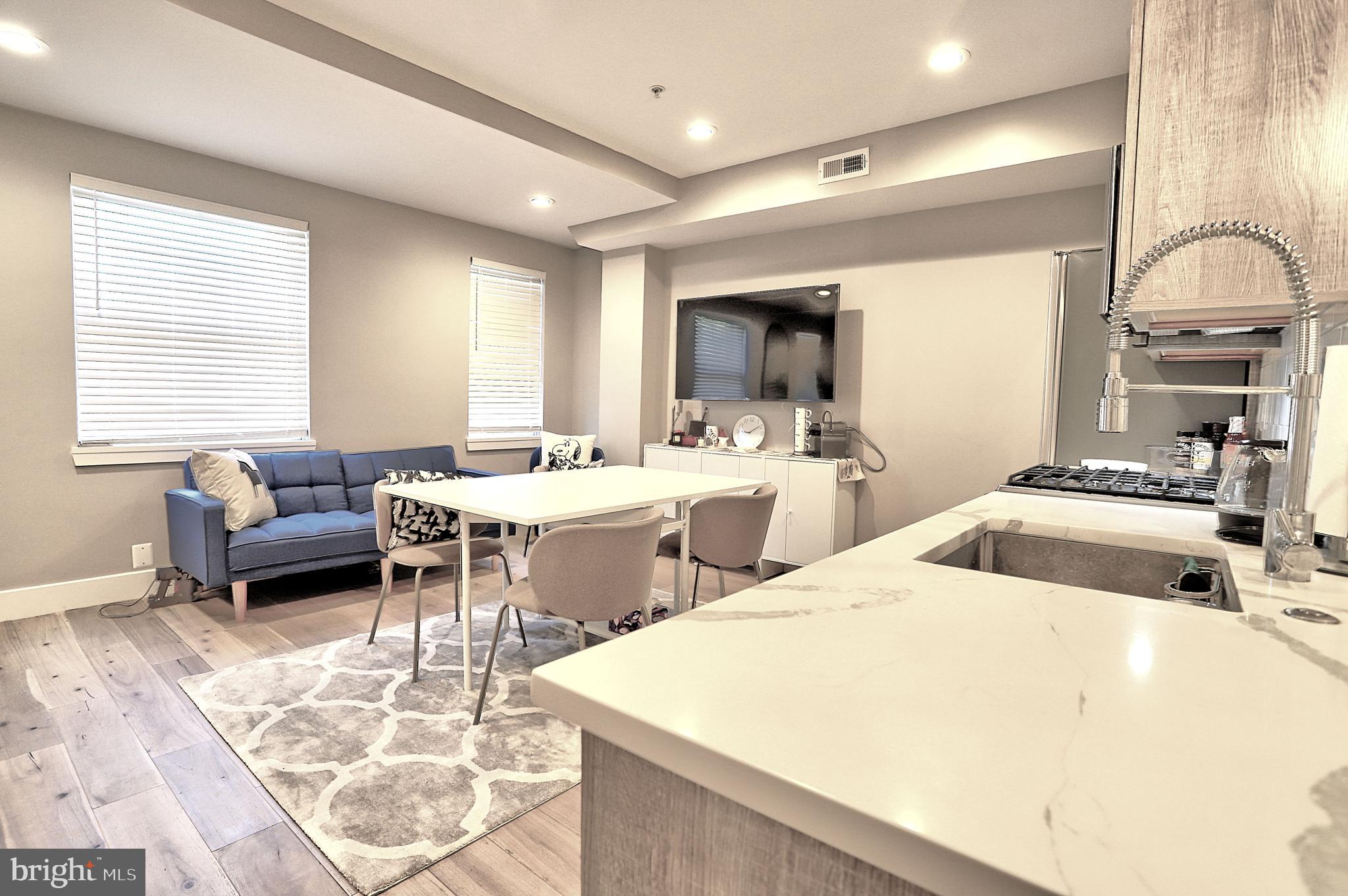 1723 Wisconsin Avenue Northwest, Unit C Washington, DC 20007 - Photo 5 of 18 a room with furniture a flat screen tv and a window