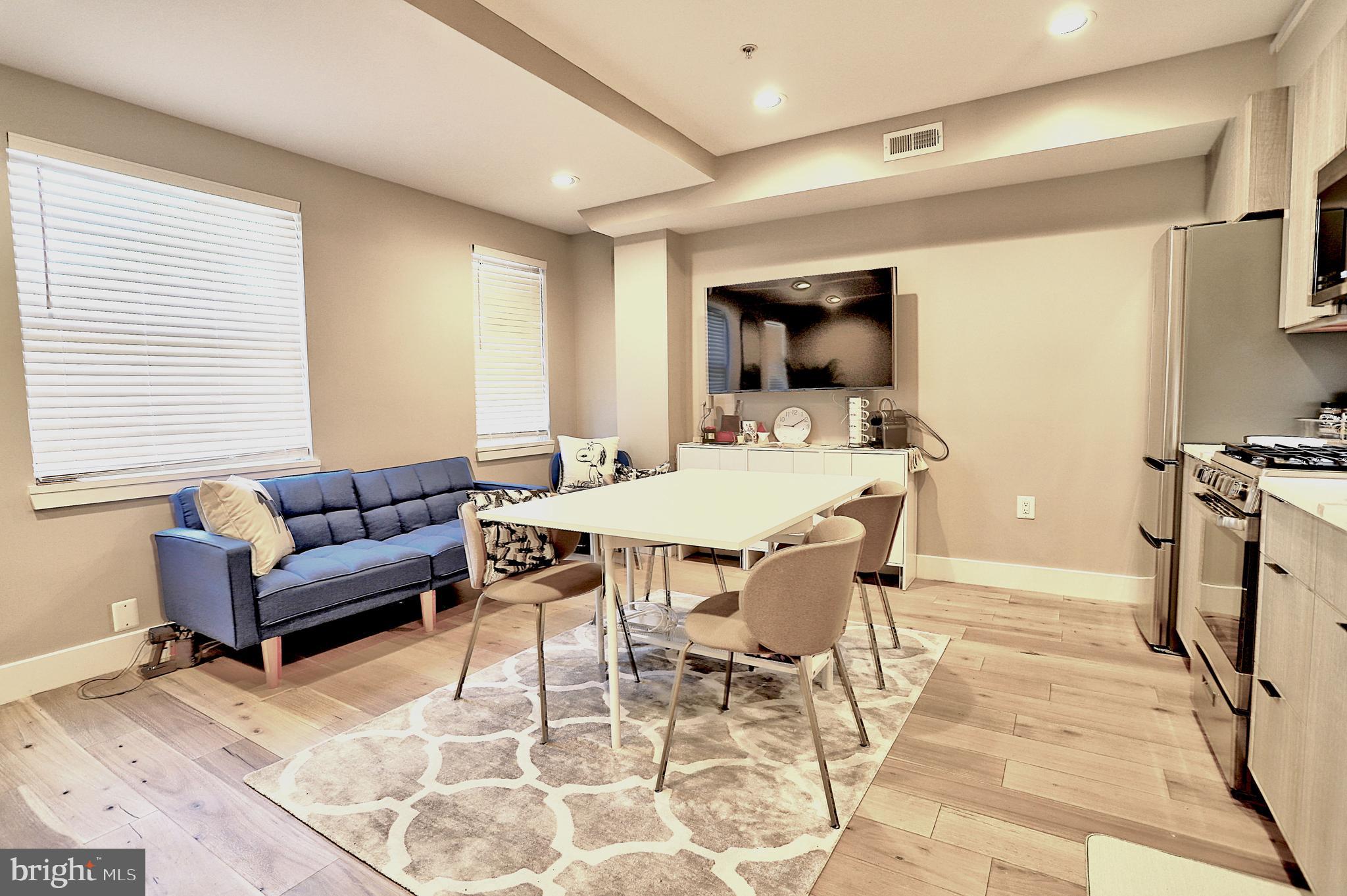 1723 Wisconsin Avenue Northwest, Unit C Washington, DC 20007 - Photo 6 of 18 a living room with furniture and a flat screen tv