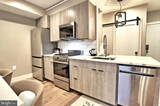 a kitchen with a sink appliances and cabinets