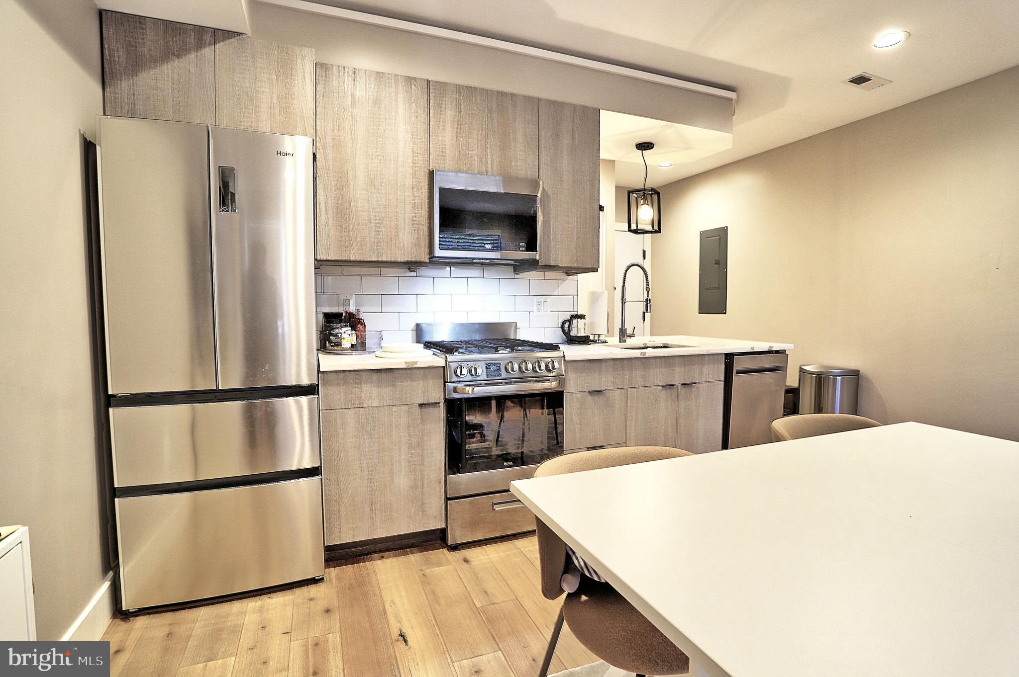 1723 Wisconsin Avenue Northwest, Unit C Washington, DC 20007 - Photo 8 of 18 a kitchen with stainless steel appliances a refrigerator sink and microwave