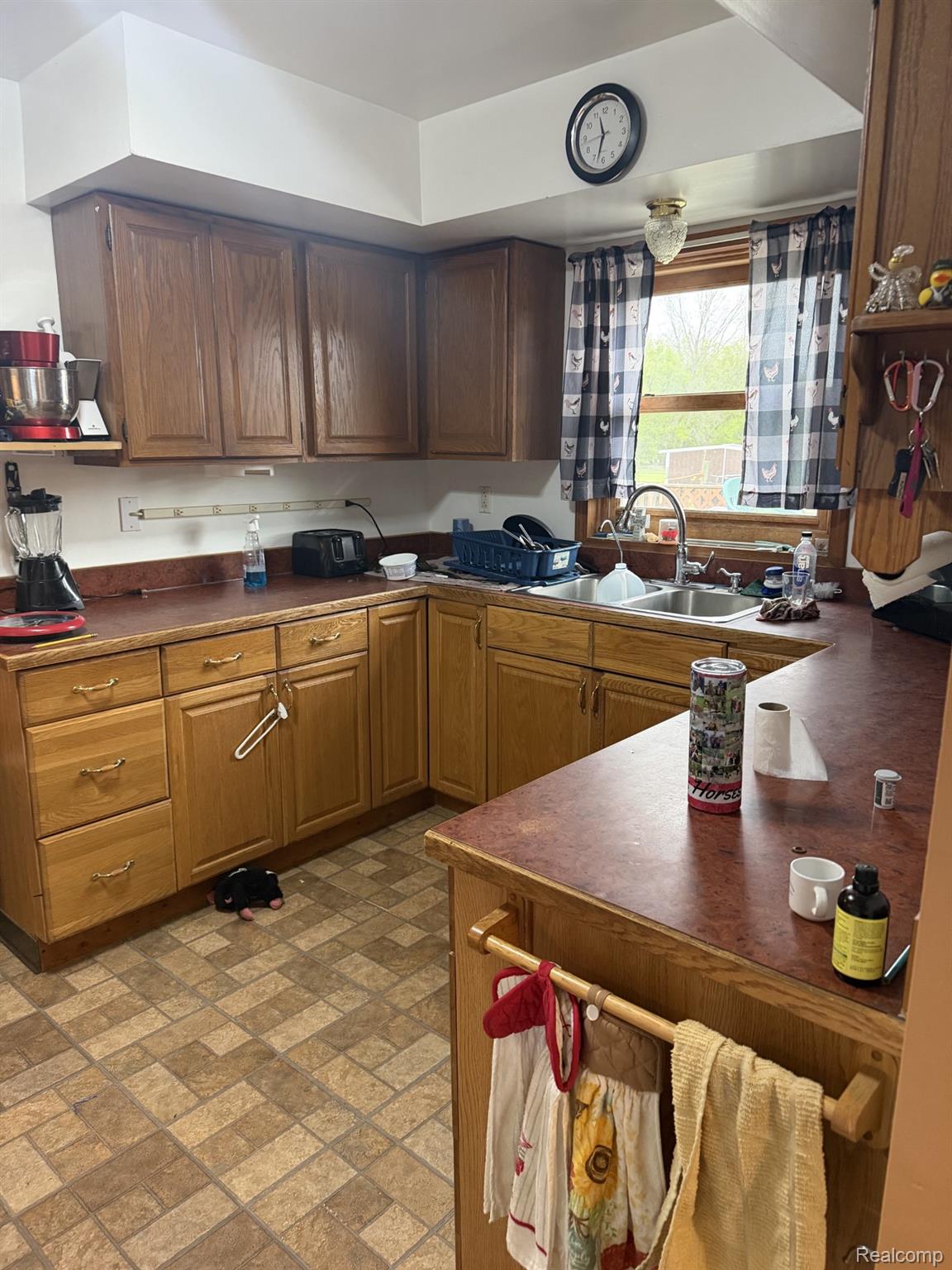 5200 Mayville Road Clifford, MI 48727 - Photo 2 of 17 Kitchen with dark countertops, brick patterned floors, and wood finish cabinetry