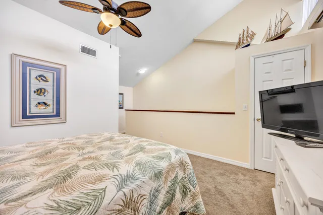 a bedroom with a bed and a television