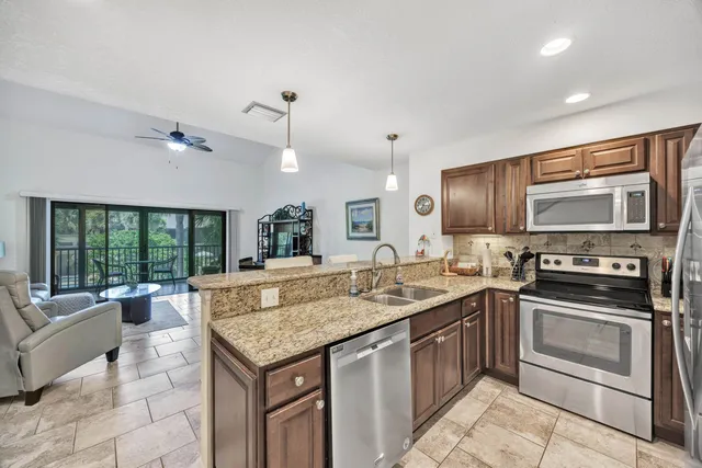 a kitchen with a stove sink and microwave