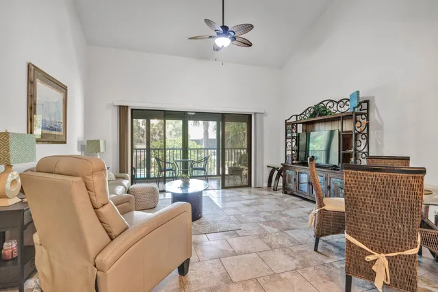 a living room with furniture two window and a fireplace