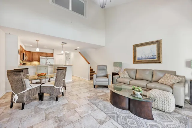 a living room with furniture and a view of kitchen