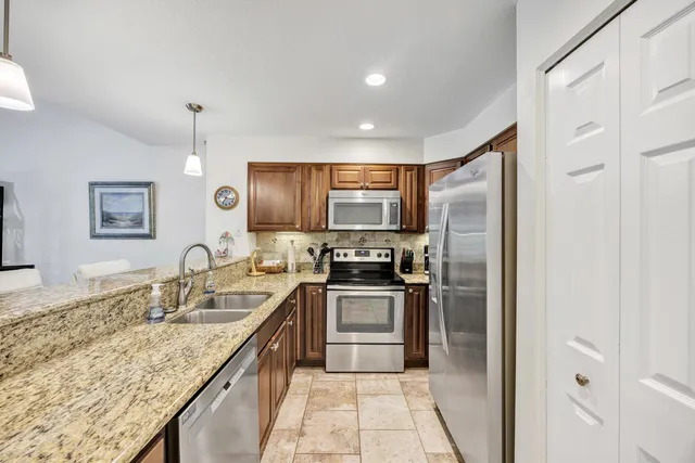 a kitchen with a sink stove and refrigerator