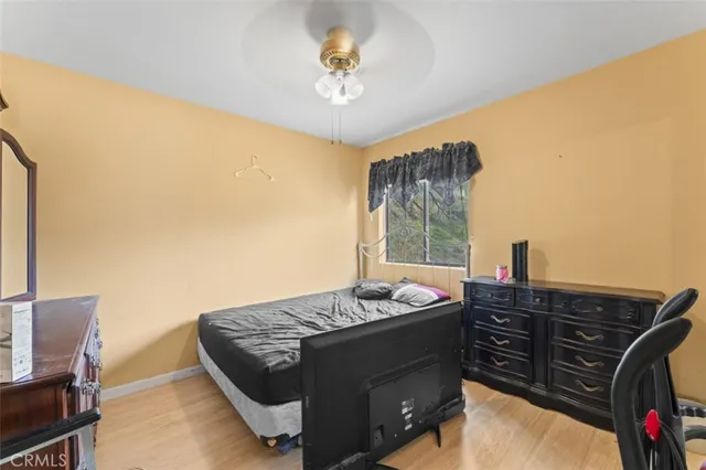 a bed sitting in a bedroom next to a window