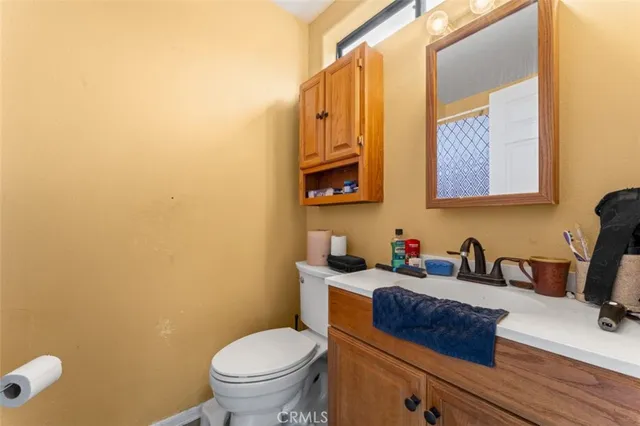 a bathroom with a toilet a sink and mirror