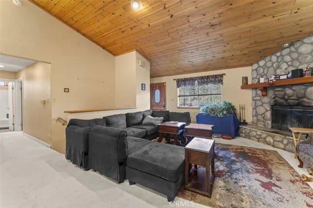 a living room with furniture a fireplace and a table