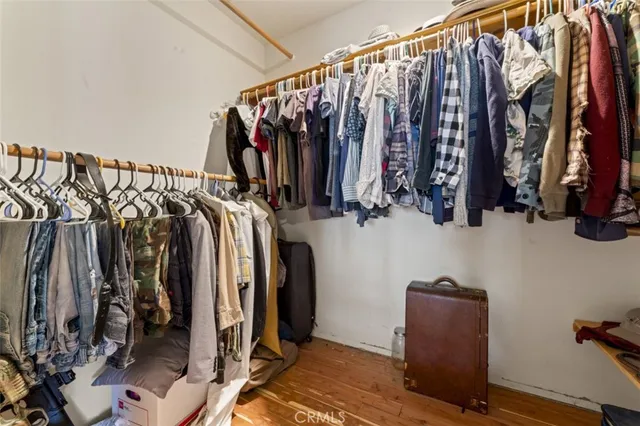 a view of walk in closet with clothes