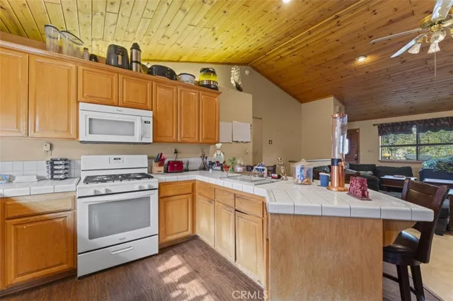 a kitchen with a stove a sink dishwasher and a refrigerator