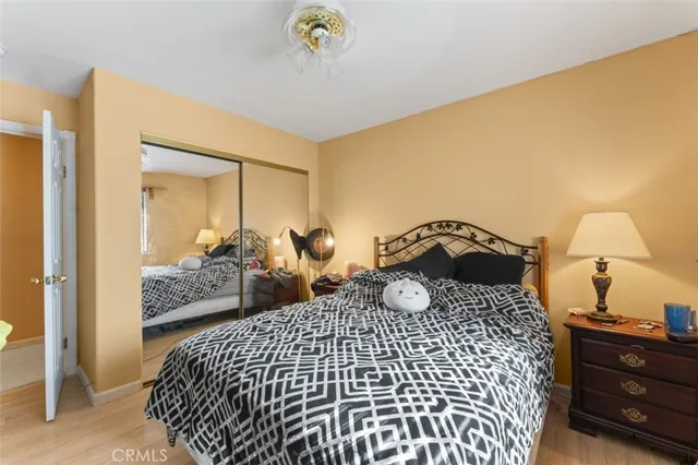 a bedroom with a bed and wooden floor