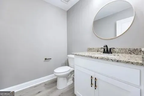 a bathroom with a sink toilet a mirror and shower