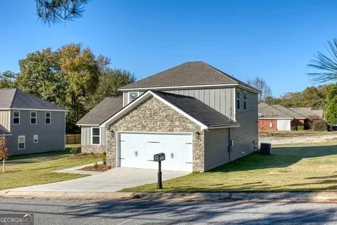 a front view of a house with a garden