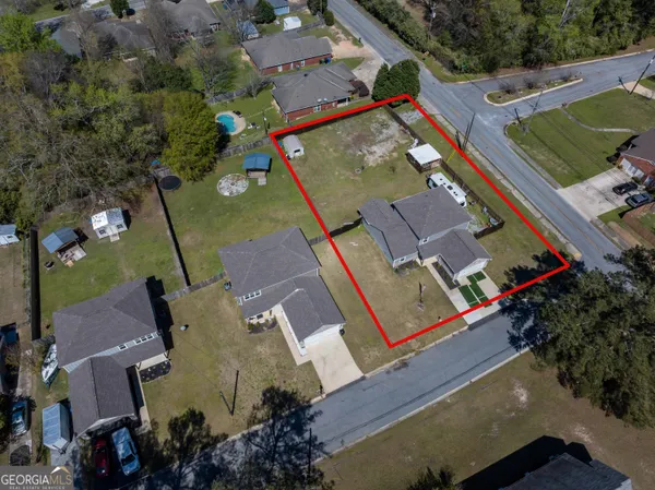 an aerial view of a house with a yard
