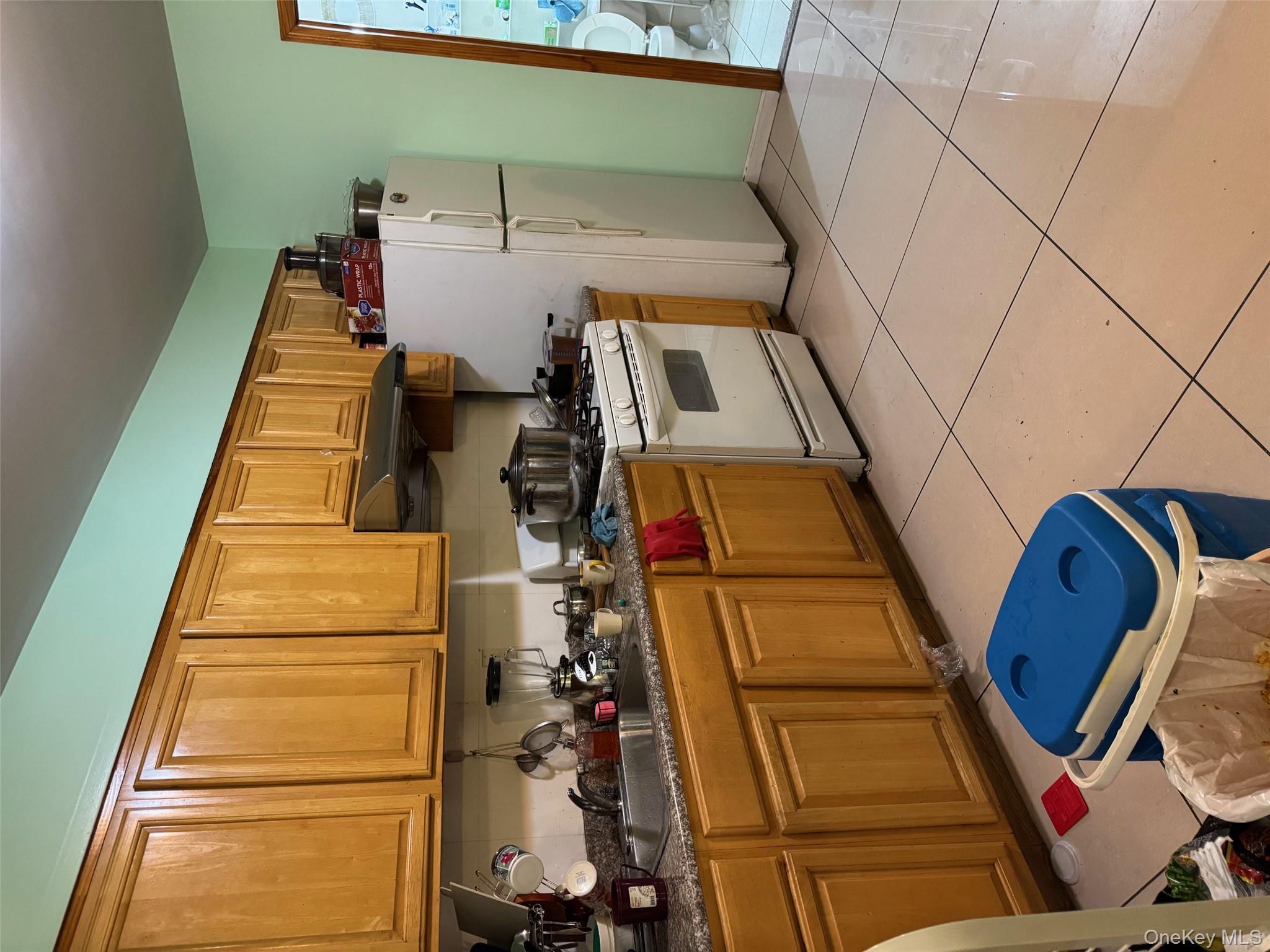 108-15 37th Drive, Unit 4B Queens, NY 11368 - Photo 2 of 10 a kitchen with stainless steel appliances granite countertop a sink stove and refrigerator