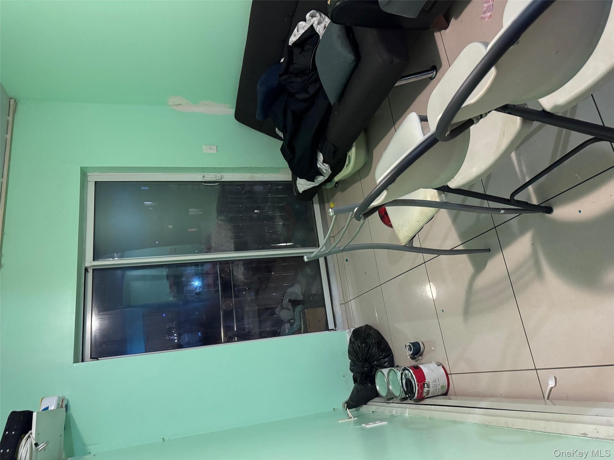 108-15 37th Drive, Unit 4B Queens, NY 11368 - Photo 3 of 10 a room with a table and chairs