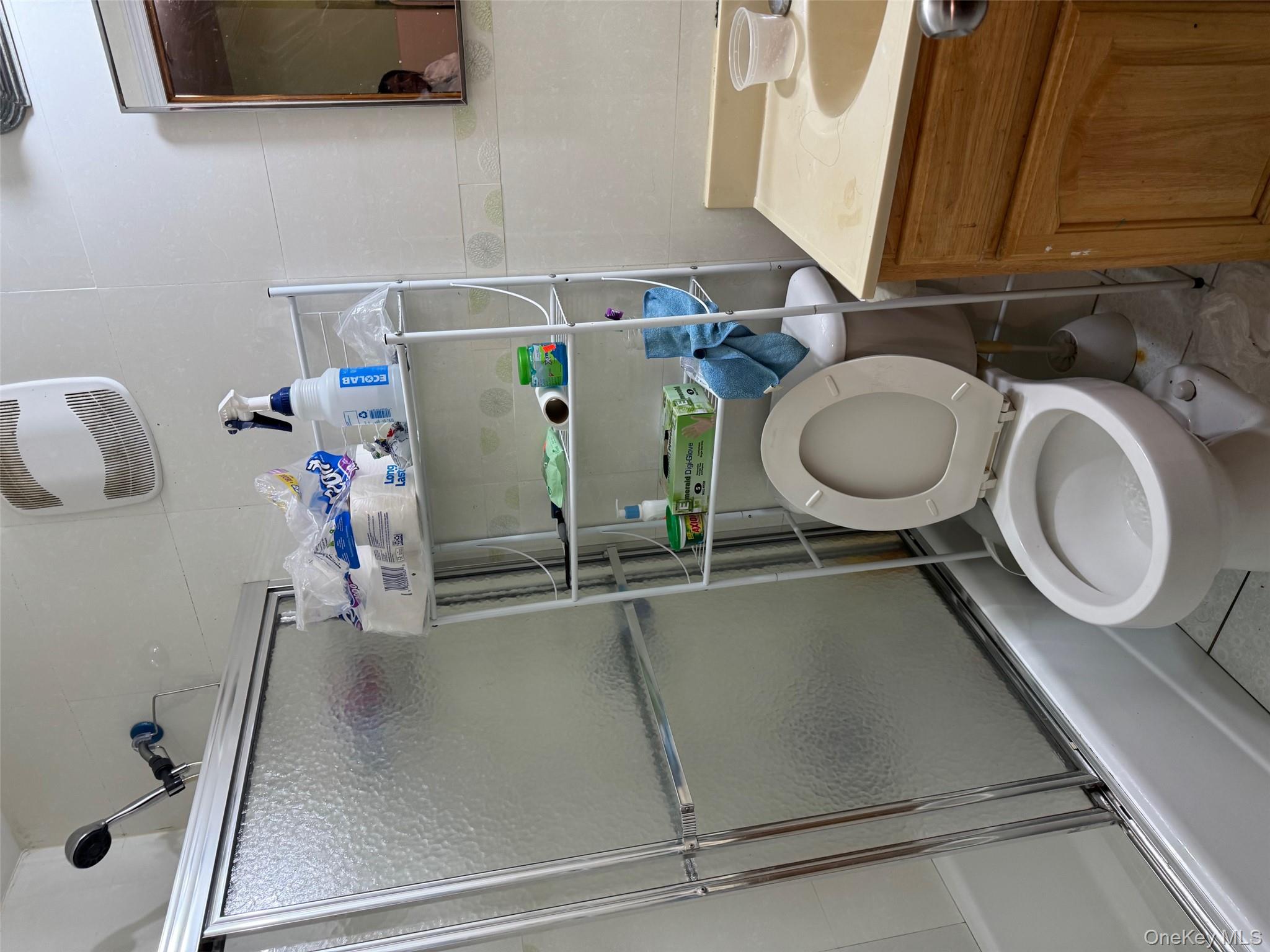 108-15 37th Drive, Unit 4B Queens, NY 11368 - Photo 7 of 10 a bathroom with a sink toilet and a mirror