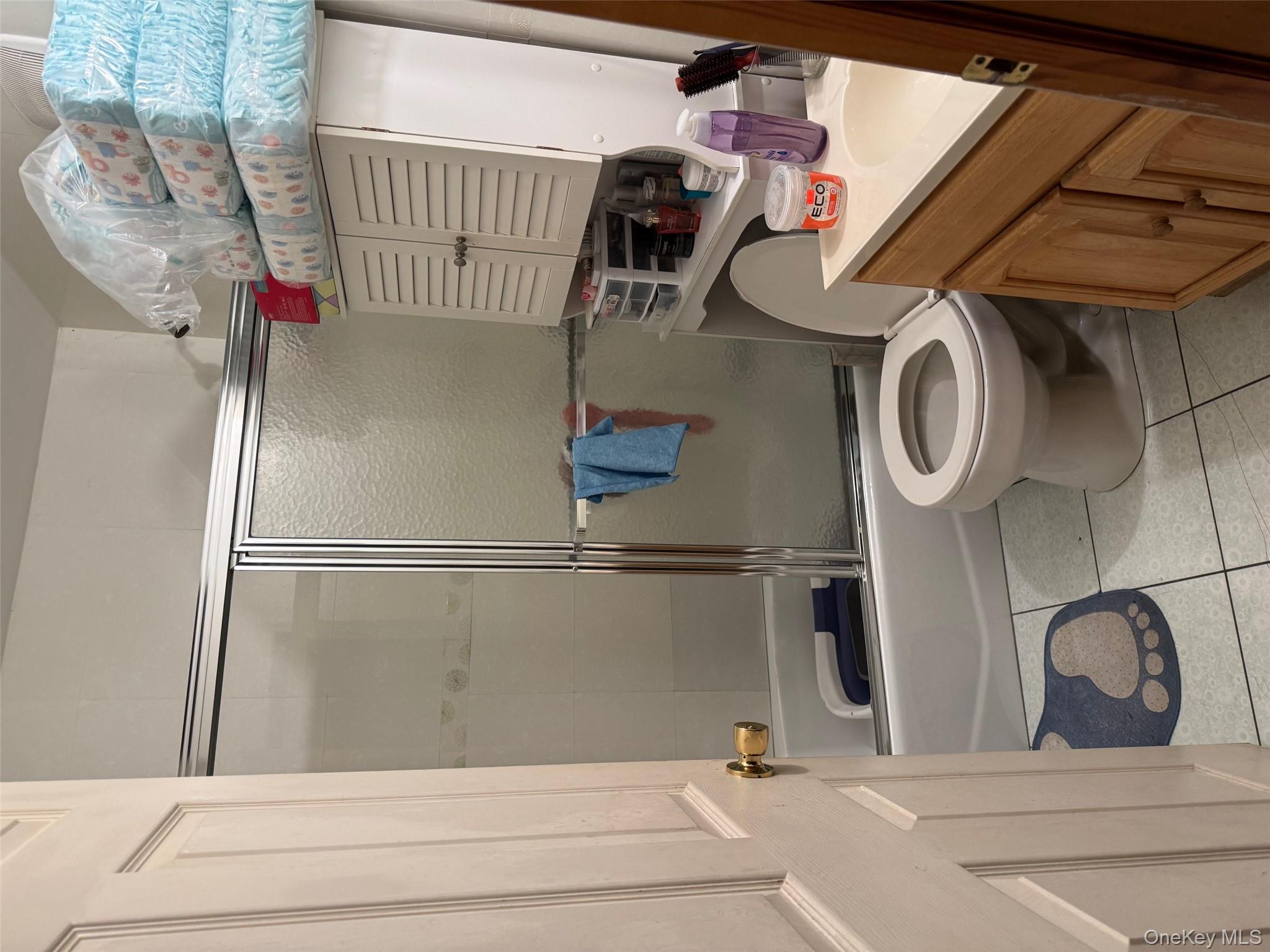 108-15 37th Drive, Unit 4B Queens, NY 11368 - Photo 8 of 10 a bathroom with a toilet and a shower