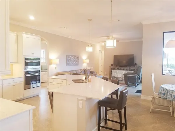 a large kitchen with a table and chairs in it