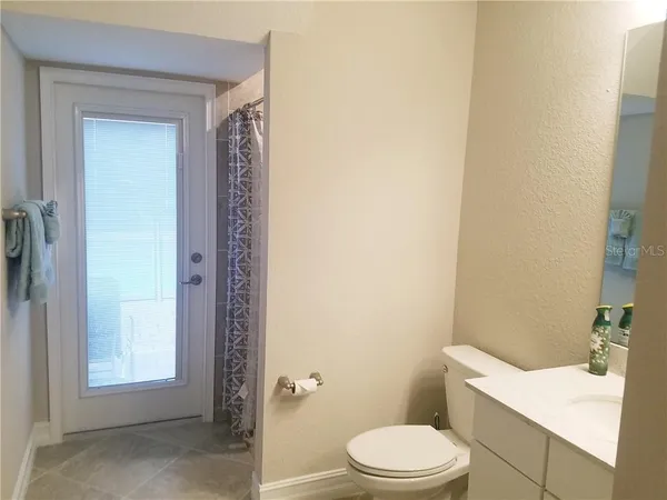 a bathroom with a toilet a sink and shower