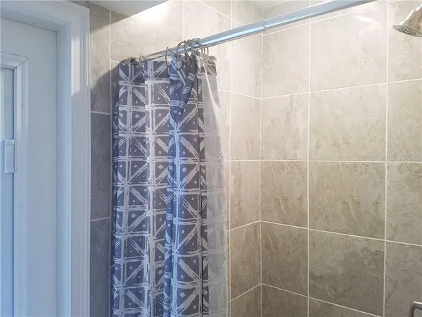 a bathroom with a shower curtain and a sink