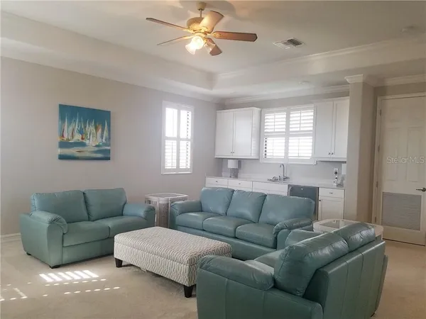 a living room with furniture a couch and windows