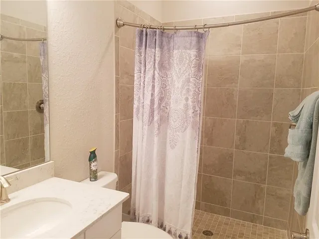 a bathroom with a sink and shower