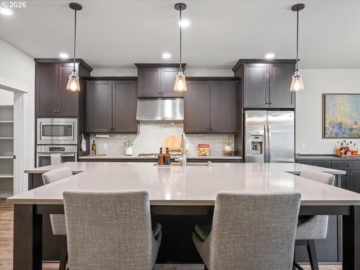 602 Northeast 149th Way Vancouver, WA 98685 - Photo 13 of 48 a kitchen with kitchen island a counter space a sink appliances and cabinets