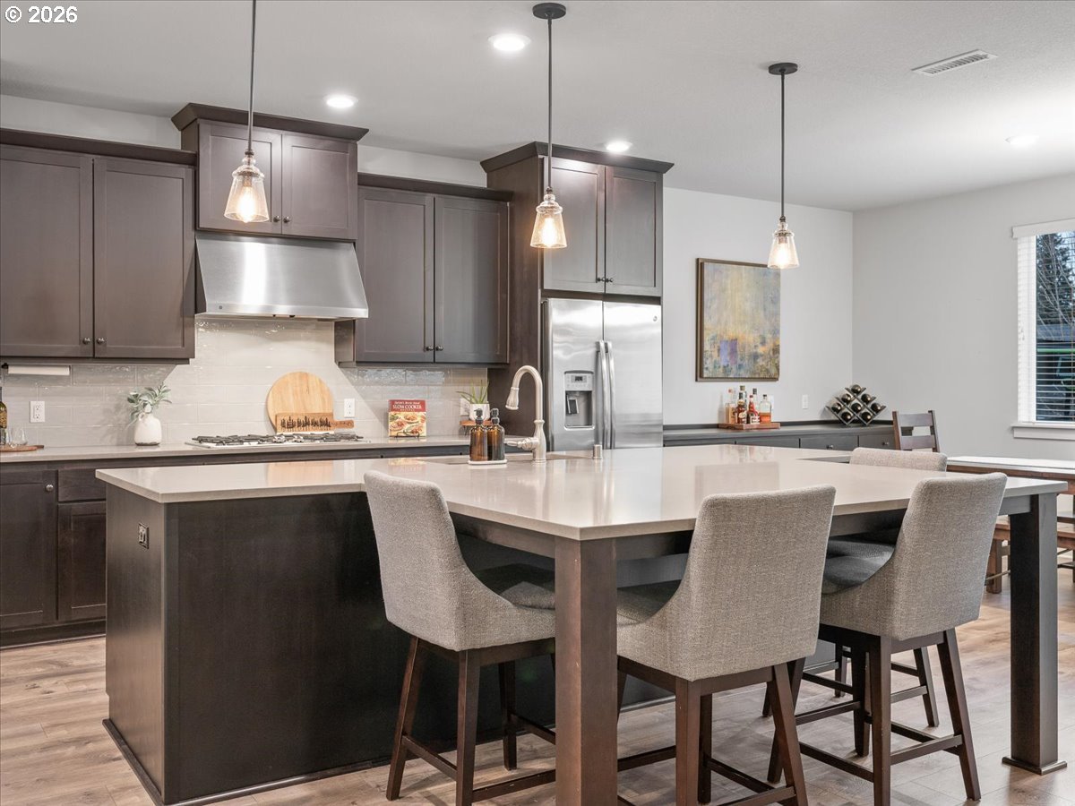 602 Northeast 149th Way Vancouver, WA 98685 - Photo 15 of 48 a kitchen with stainless steel appliances granite countertop a sink a stove a refrigerator a dining table and chairs