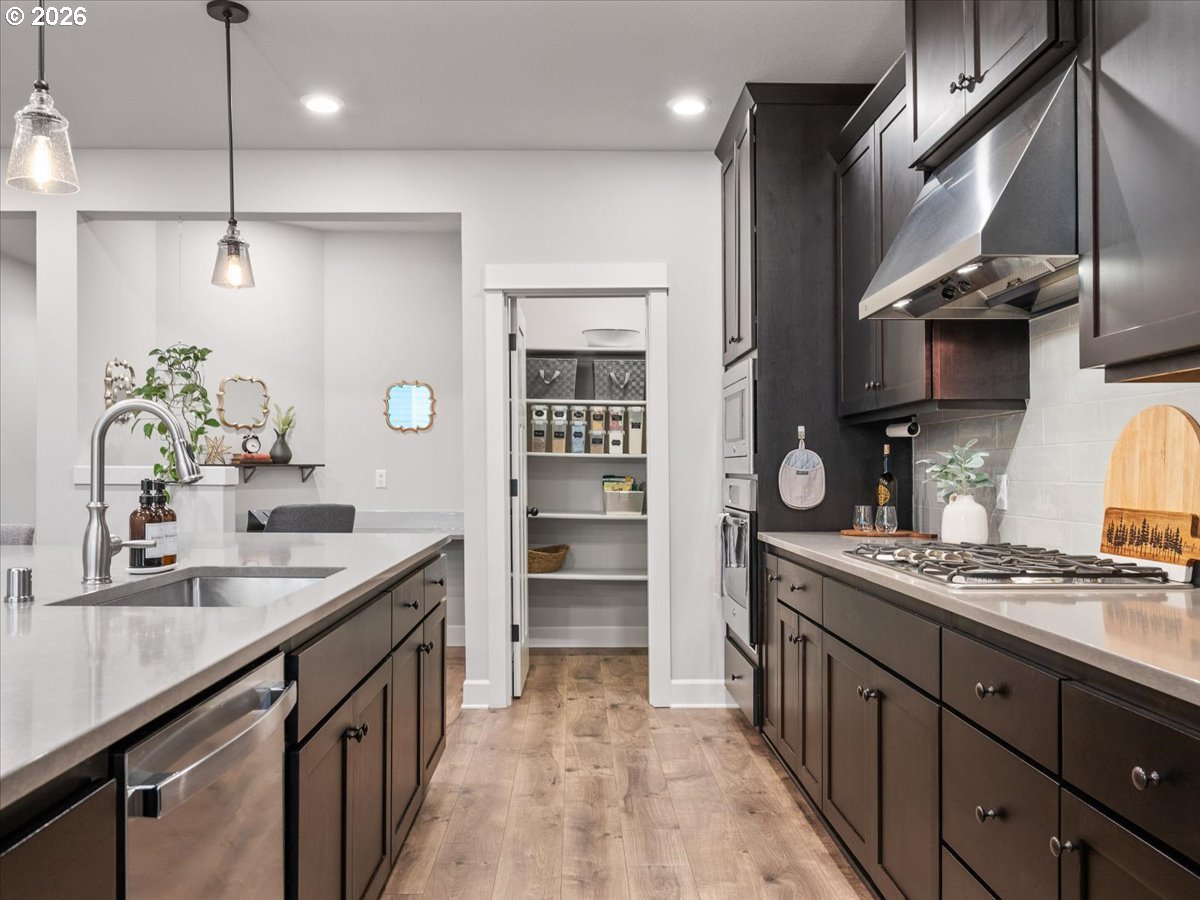 602 Northeast 149th Way Vancouver, WA 98685 - Photo 16 of 48 a kitchen with stainless steel appliances a sink stove and cabinets