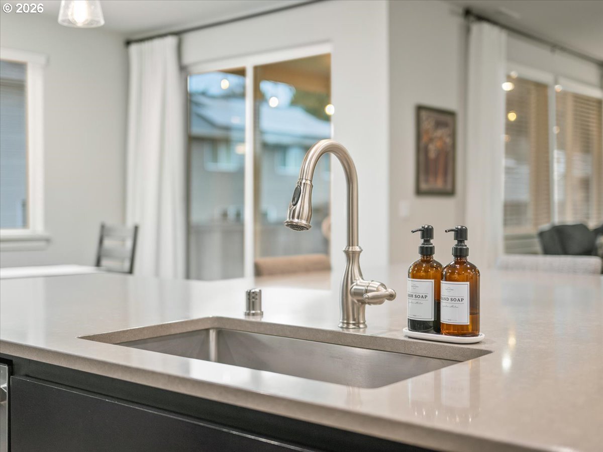 602 Northeast 149th Way Vancouver, WA 98685 - Photo 19 of 48 a kitchen with a sink and a large mirror next to a window