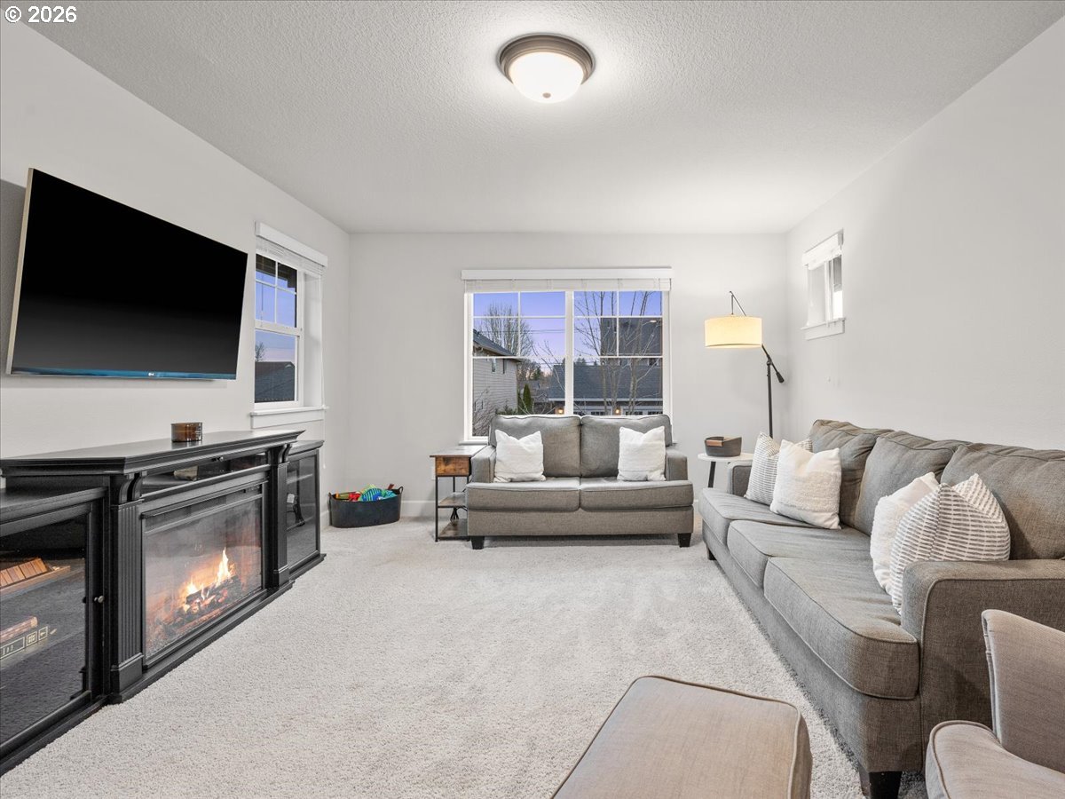 602 Northeast 149th Way Vancouver, WA 98685 - Photo 22 of 48 a living room with fireplace furniture and a flat screen tv
