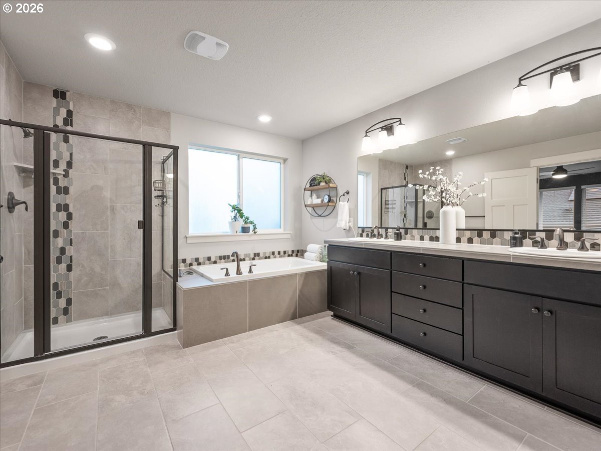 602 Northeast 149th Way Vancouver, WA 98685 - Photo 25 of 48 a large bathroom with a large mirror vanity and shower