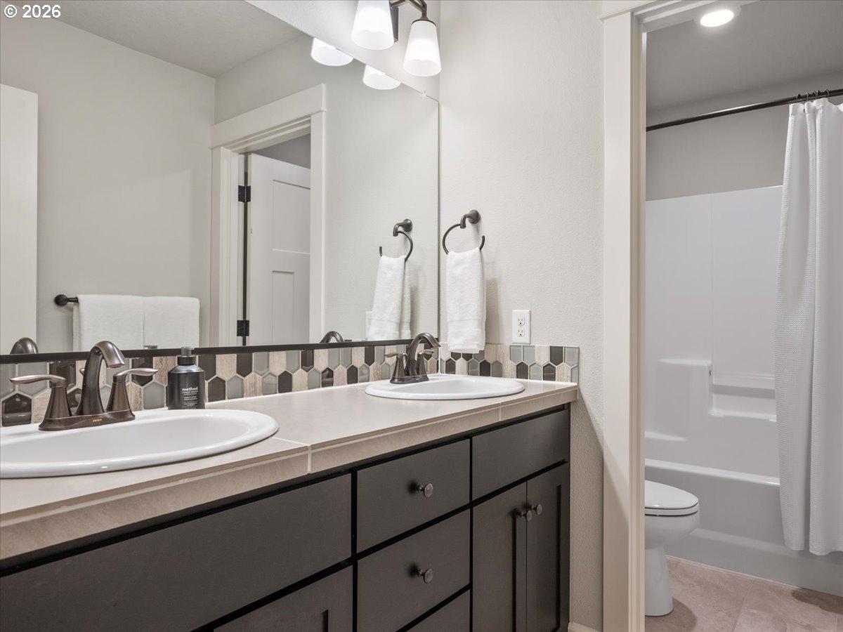602 Northeast 149th Way Vancouver, WA 98685 - Photo 34 of 48 a bathroom with a double vanity sink toilet and a mirror