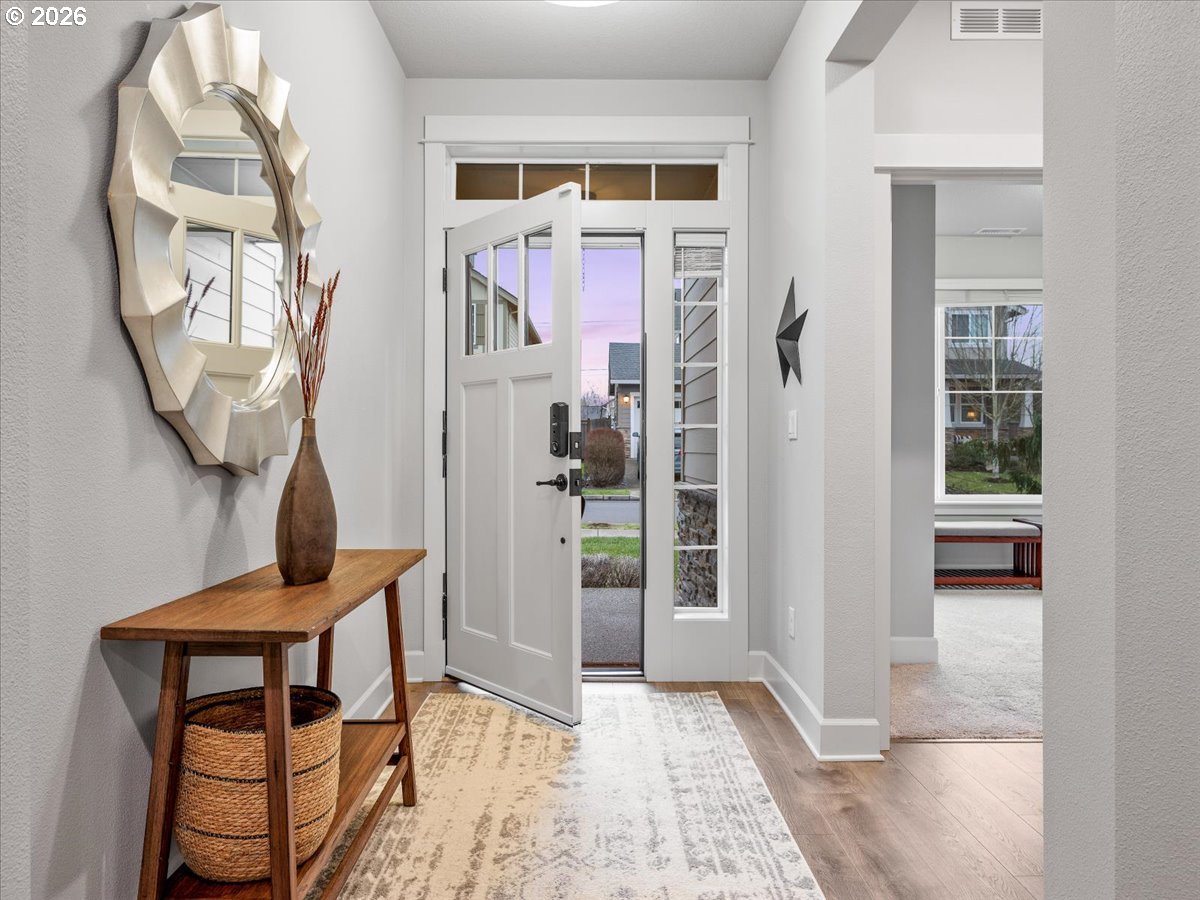 602 Northeast 149th Way Vancouver, WA 98685 - Photo 4 of 48 wooden floor in a livingroom with glass windows and a mirror