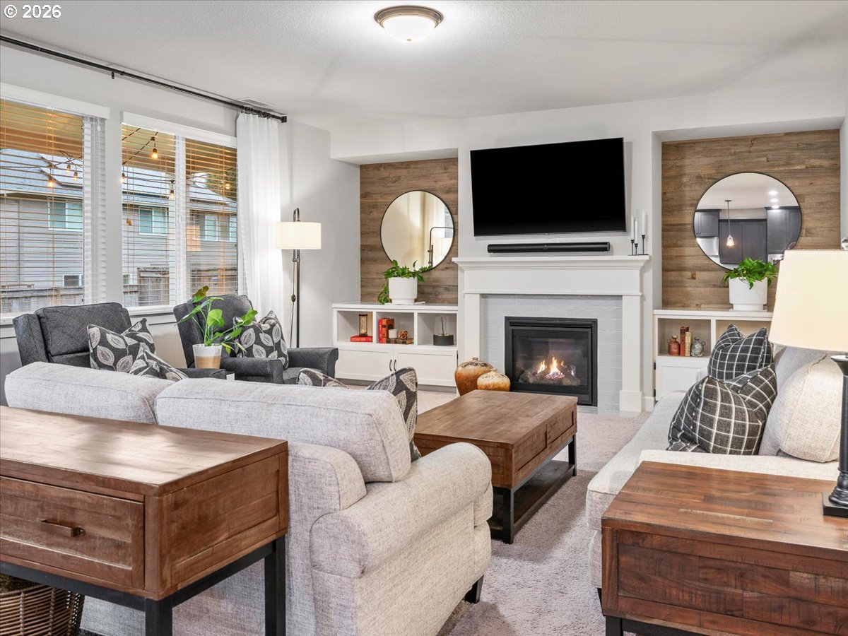 602 Northeast 149th Way Vancouver, WA 98685 - Photo 5 of 48 a living room with furniture a fireplace and a flat screen tv
