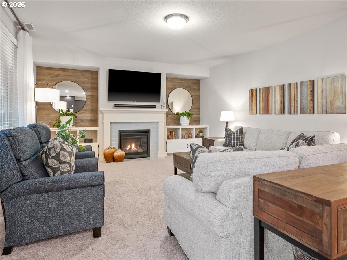 602 Northeast 149th Way Vancouver, WA 98685 - Photo 6 of 48 a living room with furniture a flat screen tv and a fireplace