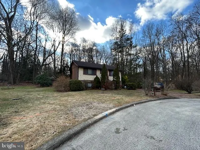 a view of a house with trees in the background